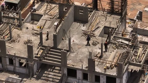 Aerial view on workers at a construction site for building a new house, 4k drone Video stock 242505928