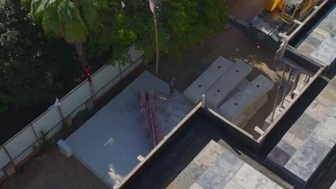 Aerial View: Workers handle heavy crane parts while engineers oversee the Stock-Footage 296101047