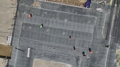 Aerial View: Workers insulate walls and prepare the foundation, creating a Stock Footage 296083272