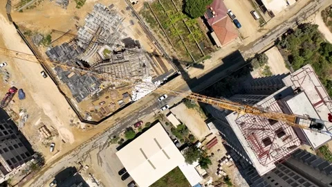 Aerial View: Workers labor diligently on a bustling construction site in a new Stock Footage 296128095