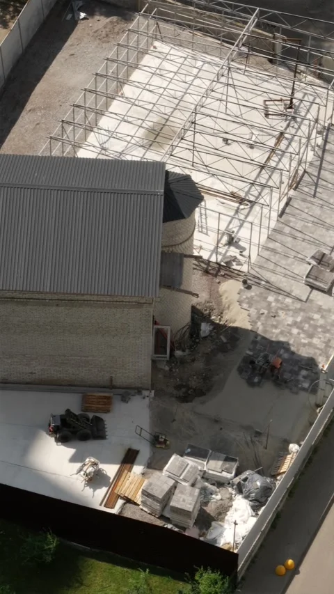 Aerial view of workers laying paving stones near house vertical Stock Footage 339794842