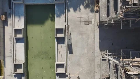 Aerial View: Workers load materials and assemble metalwork at a construction Stock Footage 296174642