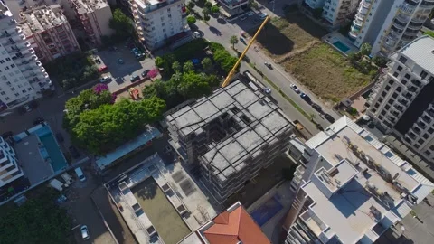 Aerial View: Workers position and assemble crane sections while engineers ensure Stock Footage 296098543