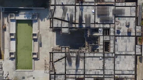 Aerial View: Workers shape and set rebar while concrete is poured for strong Stock Footage 296173284
