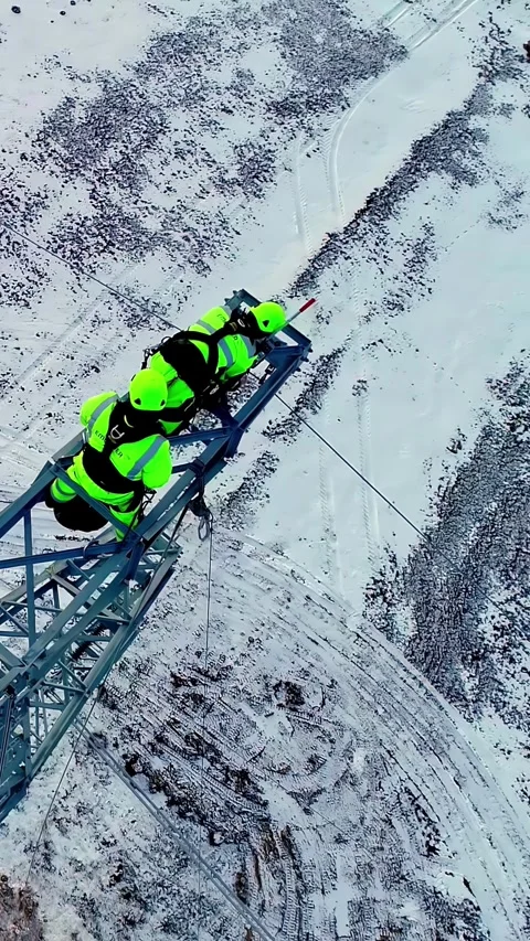 Aerial view of workers on a tall tower in winter, Latvia. Stock Footage 340635340