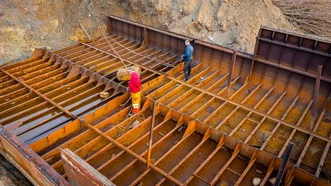 Aerial view on workers as they manually cutting old ship with blowtorch Stock Photos