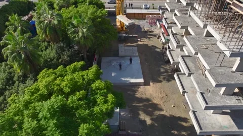Aerial View: Workers use heavy equipment to install massive crane sections while Stock Footage 296099670