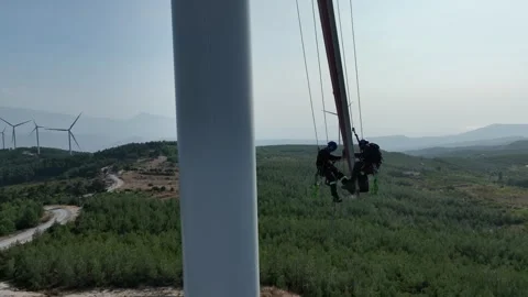 Aerial view of workers working at wind power plant 3 Stock Footage 294949215