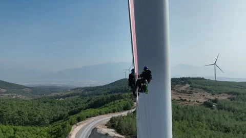 Aerial view of workers working at wind power plant 2 Stock Footage 294949226