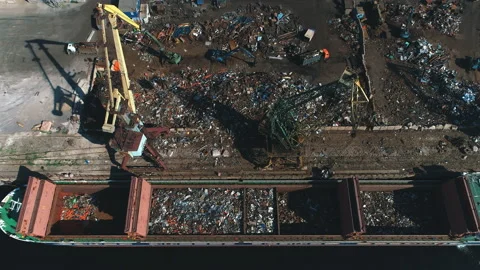 Aerial view on a working crane at a scrap heap will load iron Stock Footage 99738642