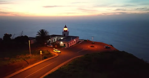 Aerial view to working lighthouse at dusk time located on a picturesque rock 動画素材 269709327