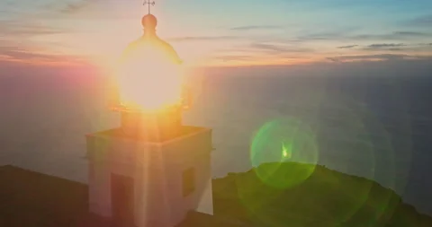 Aerial view to working lighthouse at dusk time located on a picturesque rock Vídeos de archivo 270601726
