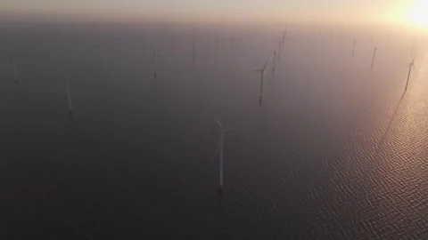Aerial view of working offshore wind farm at ocean during sunrise, Netherlands Stock Footage 268477505
