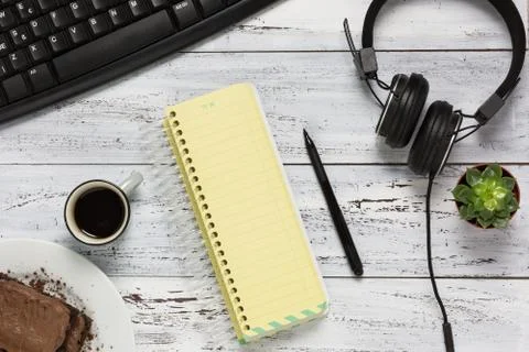 Aerial view workplace with empty yellow notebook Stock Photos