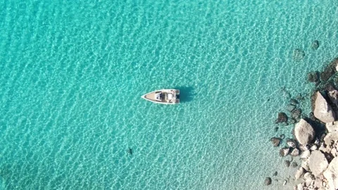 Aerial view of a yatch in the crystal clear waters of a beach. Stock Footage 207702804