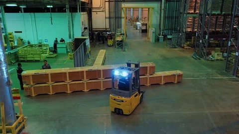 Aerial view of a yellow loader transporting cargo in large mail warehouse Stock Footage 113091197