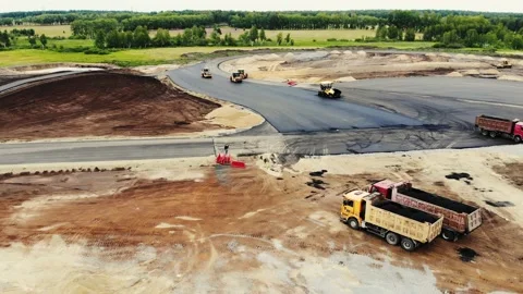Aerial view of the yellow road rollers that lay asphalt on the testing ground Stock Footage 166488512