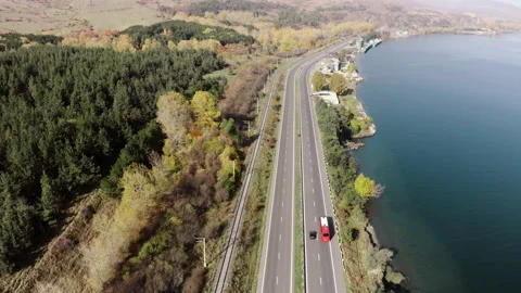 Aerial view of Yerevan-Sevan highway. Travel red tour bus driving on asphalt Stock Footage 171211389
