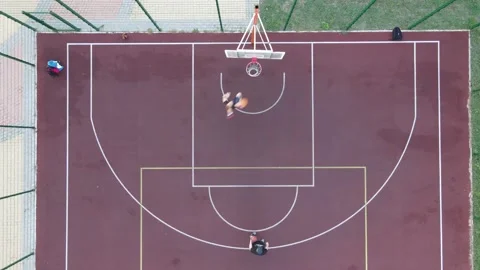 Aerial view of a young guy playing basketball on the street Stock Footage 148964361