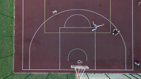 Aerial view of a young guy playing basketball on the street Stock Footage 148964435