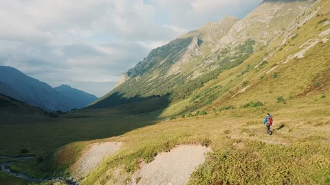 Aerial view: young guy walking on nature Stock Footage 118433926