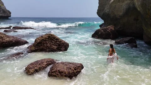 Aerial view of young lady on Diamond Beach, Nusa Penida, Bali. Indonesia Stock Footage 319924564