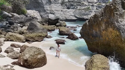 Aerial view of young lady on Diamond Beach, Nusa Penida, Bali. Indonesia Stock Footage 319924565
