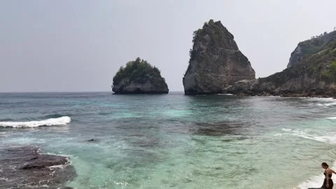 Aerial view of young lady on Diamond Beach, Nusa Penida, Bali. Indonesia Stock Footage 320107349