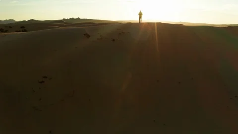 Aerial view of a young man in the desert on a sand dune. Sahara Desert. Video stock 126201799