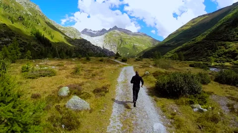 Aerial view of young man running alone in mountain landscape Video stock 42278329