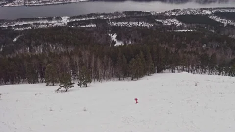 Aerial view of a young man skiing down a snowy mountainside. Stock-Footage 180615904