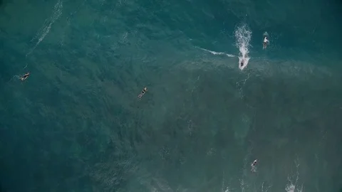 Aerial view of young man stand up paddle boarding on blue ocean waves Stock-Footage 76694849
