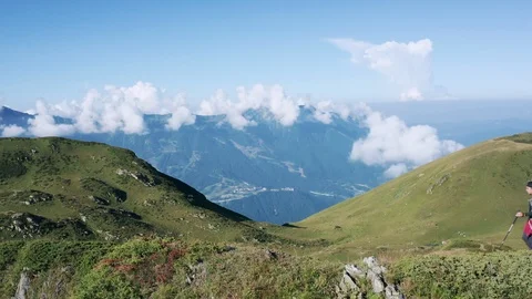 Aerial view; a young man walking on mountain peak Stock Footage 118373383