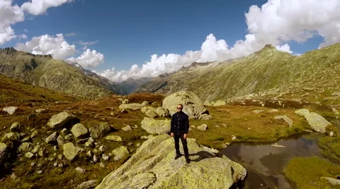 Aerial view of young single man standing on rock in mountain lake landscape Stock Footage 42278874