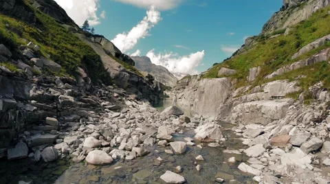 Aerial view of young single man standing on rock inside canyon landscape Stock-Footage 64804968