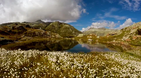 Aerial view of young single man walking around mountain lake Stock-Footage 64805016