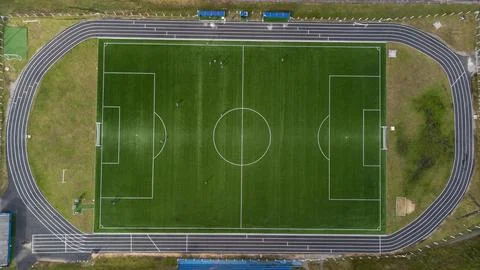 Aerial view from zenith/nadir angle down of a soccer field on a sunny day, wh Stock Photos