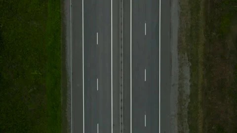 Aerial view(camera down) of Empty Highway next to Forest, Mountains Range Stock Footage 163099972