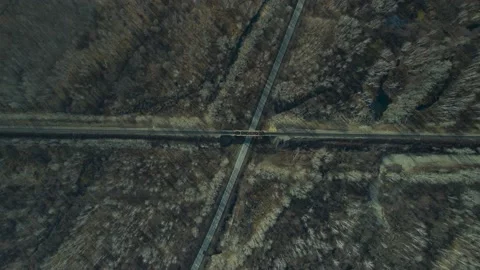 Aerial view(camera down) of the Railroad Bridge above Highway, Sun, in Late Fall Stock Footage 165466703
