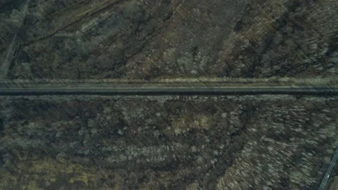 Aerial view(camera down) of the Railroad Bridge above Highway, Sun, in Autumn Stock Footage 165466875