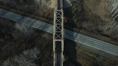 Aerial view(camera down) of the Railroad Bridge above Highway with Car Stock Footage 165475711