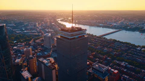 Aerial viewpoint above Prudential Tower looking toward Charles River at sunset Stock Footage 340554053
