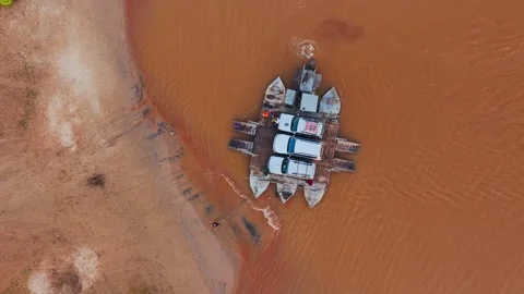 Aerial views capture a ferry transporting vehicles and passengers across a wide 스톡 동영상 308395038