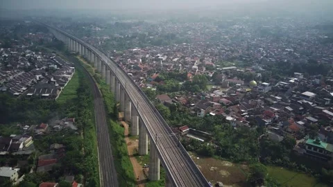 Aerial Views: Drones Soar Above Bandung's Fast and Regular Train Tracks Stockbeeldmateriaal 244045504