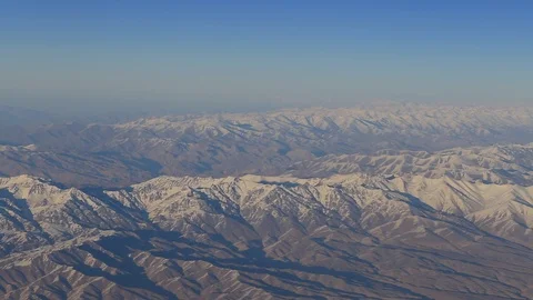 Aerial views in mountain. View from the plane window. The Hindu Kush mountain Video stock 89076024