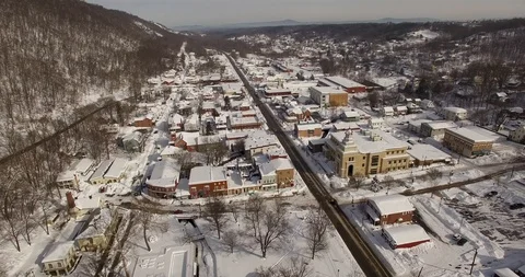 Aerial views of snow covered Berkeley Springs, WV in the Appalachian Stock Footage 100218925