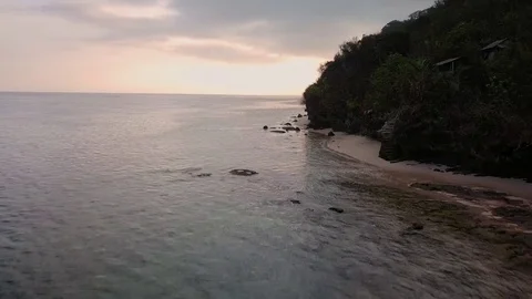 Aerial views of sunset along cliffs in Bali Stock Footage 80842998