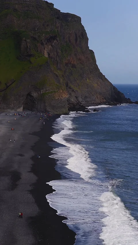 Aerial of Vik black sand beach and basalt cliff, Iceland, daylight Stock Footage 340834520