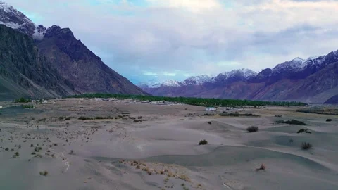 Aerial visual of cloud cover moving slowly over the wide expanse of Nubra’s Stock Footage 310806965