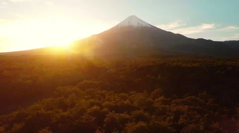 Aerial: Volcano Backward Tracking Over Forest At Sunset In The Wilderness 2K Vídeo Stock 64679350